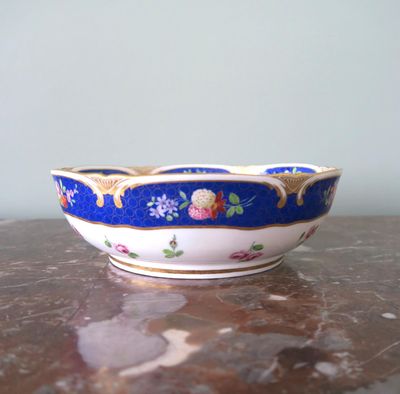 a blue and white bowl sitting on a marble table