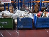 many bins of garbage on the floor in the warehouse