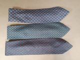 three different colored ties are lined up on a table