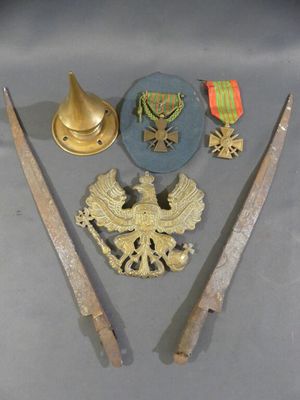two swords, a hat, and a medal are on a table