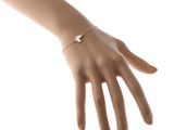 the hand of a woman wearing a bracelet with a star on it
