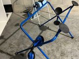 an image of a blue walker with wheels in a garage