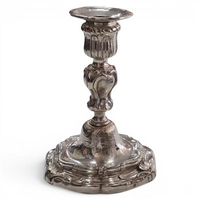 a silver candle holder with a bird on it