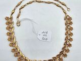 a gold plated necklace with leaves and leaves on it