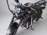 a black motorcycle that is parked on a white floor