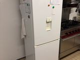a white refrigerator in a kitchen with a stove and oven