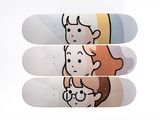 three skateboards with cartoon characters on them stacked on top of each other