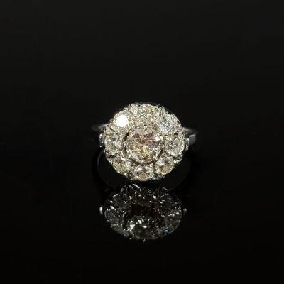 an old cut diamond ring on a black surface