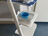 a white cart with a blue bowl on top of it