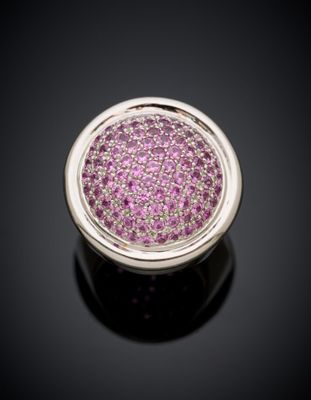 a close up of a pink diamond ring on a black surface