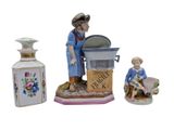 a figurine of a man and a woman next to a bottle of liquor