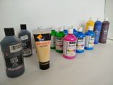 many different colors of paint on a counter top