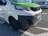 a white and green van parked on the side of the road