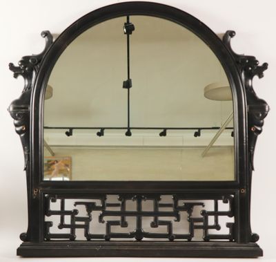 an image of a mirror with a black frame on a white wall