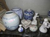 many vases and figurines sitting on a glass table