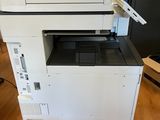 a white printer sitting on top of a wooden floor