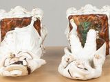 two figurines that are sitting on a table