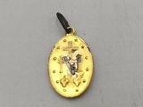 a close up of a gold coin with a cross on it