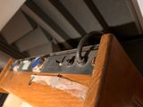 a close up of a wooden cabinet with a bunch of wires on it