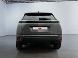 the rear end of a grey suv parked in a garage