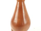 a small brown vase with a gold top on a white surface