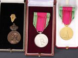 three medals and a medal in a case on a table