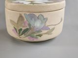 a white box with a flower on it on a table