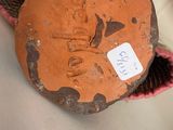 a person holding a piece of wood with a tag on it