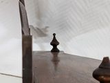 a wooden table with a knife on it next to a piece of paper