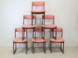 six pink chairs stacked on top of each other