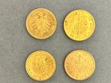 four gold coins, one of which is a sovereign and one of which is a sovereign