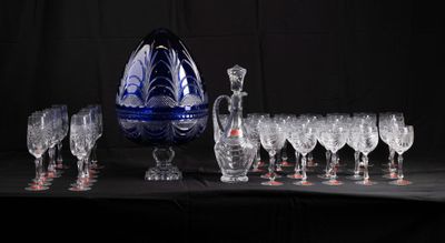 bottles and glasses are lined up on a table with a black background