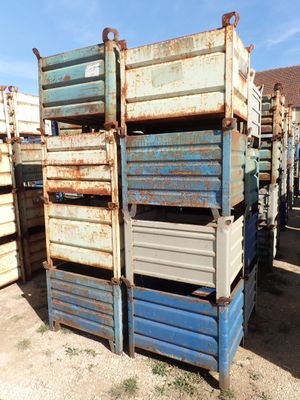 many crates stacked on top of each other in the dirt