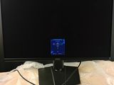 an image of a monitor on a bed with a charger