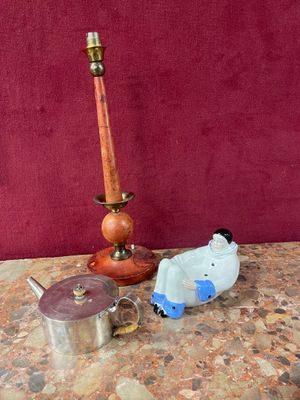 a table with a candle, a teapot, and other items on it