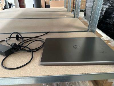 a laptop computer sitting on a table next to a charger