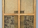 an old window with a wooden frame and a window pane on the outside