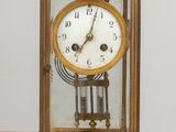 a clock that is sitting on a wooden table