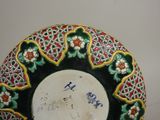 a decorative plate with writing on it sitting on a table