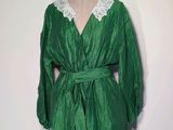green dress with white lace collar on a mannequin dummy