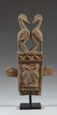 a close up of a wooden sculpture with two birds on it