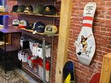 a room with a bunch of skateboards and other items on the wall