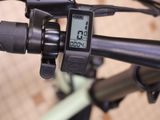 a close up of a bike handlebar with a clock on it