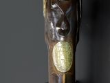 a close up of a gun with a metal handle on a black background