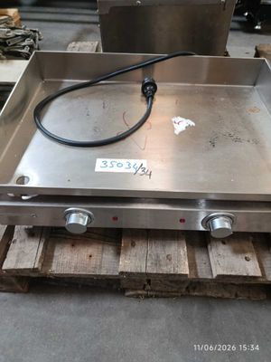 an image of a stainless steel stove top on a pallet in a warehouse