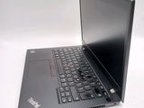a laptop with a black keyboard on a white surface