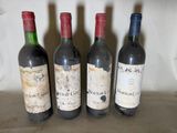 four bottles of wine are lined up on a table