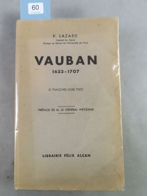 un vieux livre posé sur une table, à côté d'une étiquette bleue