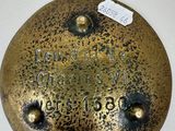 an old brass plate with the name of a man on it