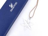a blue box with a silver snowflake ornament on it